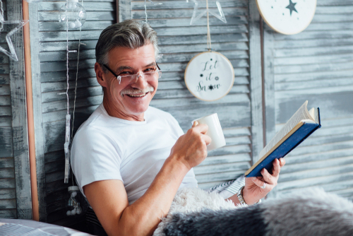 Man reading a book with reading glasses after toric IOL