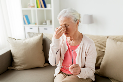 Eye doctor consulting senior patient, guiding toward ethical lens implant options