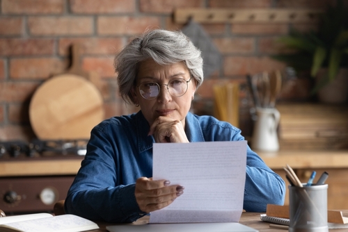 Two elderly women examining phone closely, motivating need for vision-enhancing treatment