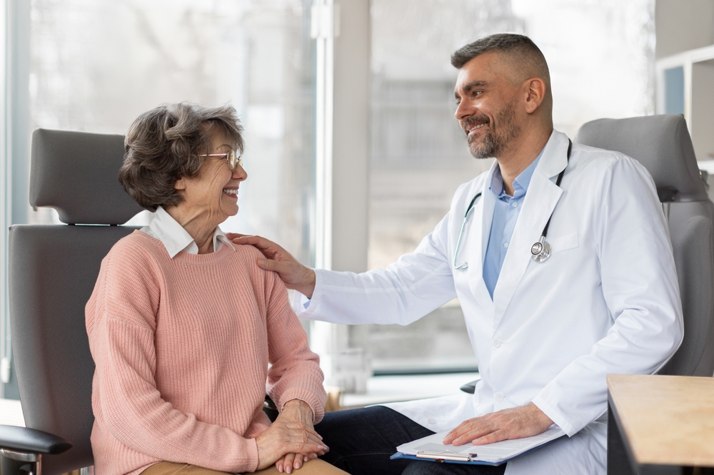 Eye doctor consulting smiling senior woman in clinic