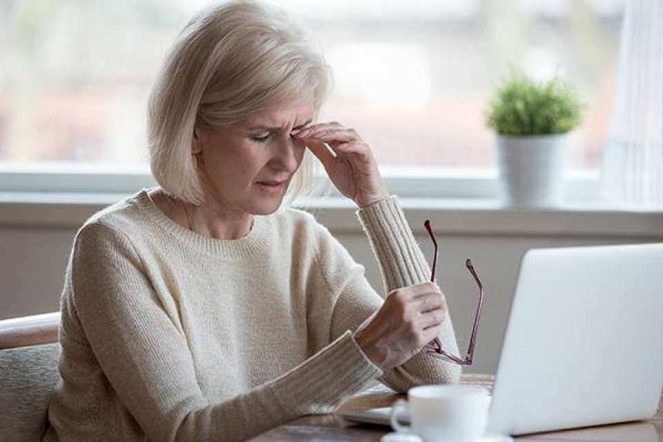 Woman with dry eye disease tries to relieve her pain.