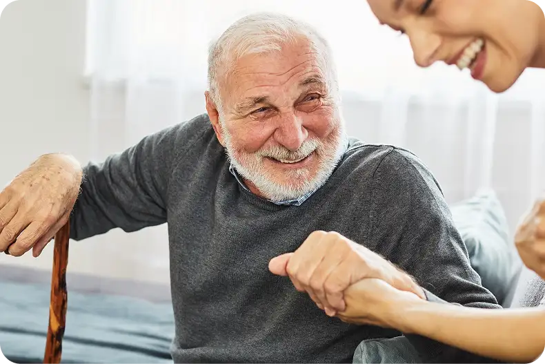 Thoughtful senior on sofa touching chin – clarity after premium lenses.