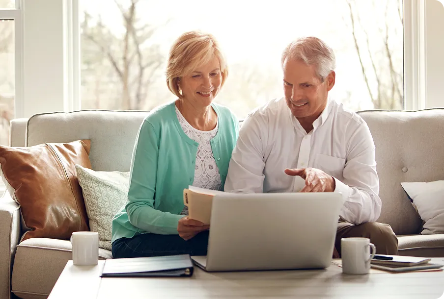 Senior couple fill out new patient intake forms.